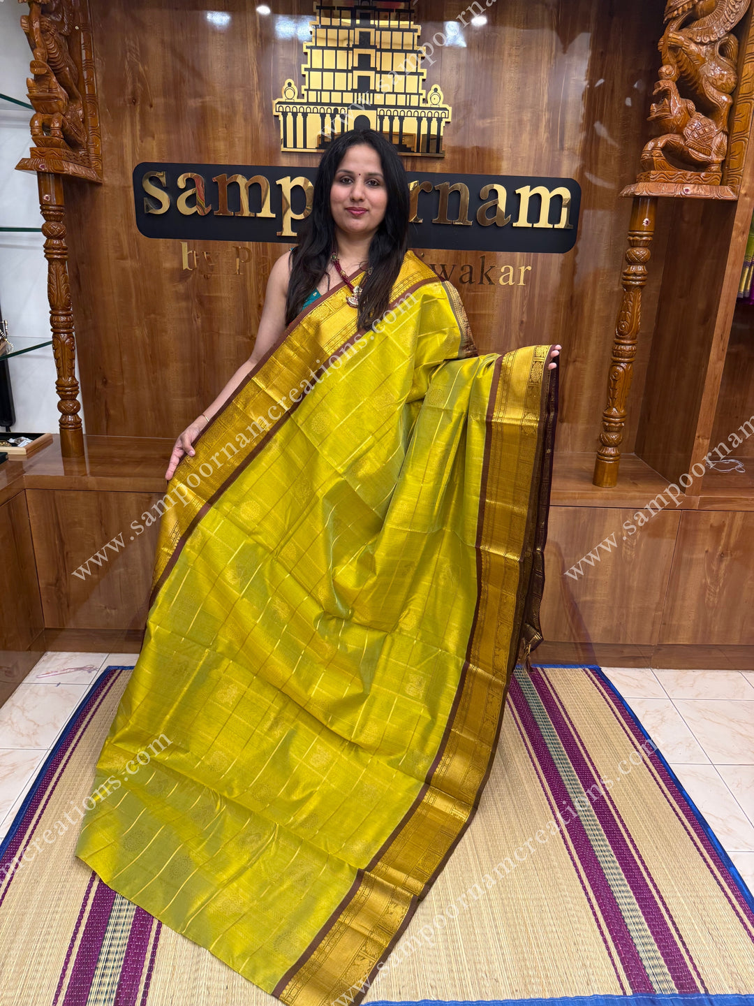 Lemon Green with Brown , rich Zari checks in the body , Mayil and Chakram rich butta in the body , traditional border and rich Pallu Silk Cotton Saree