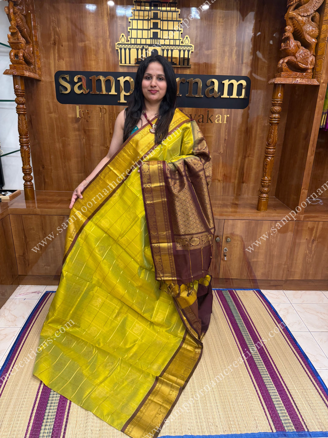 Lemon Green with Brown , rich Zari checks in the body , Mayil and Chakram rich butta in the body , traditional border and rich Pallu Silk Cotton Saree