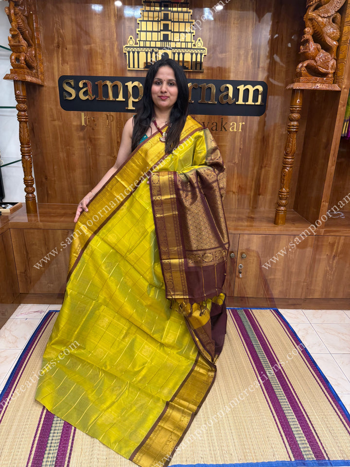 Lemon Green with Brown , rich Zari checks in the body , Mayil and Chakram rich butta in the body , traditional border and rich Pallu Silk Cotton Saree