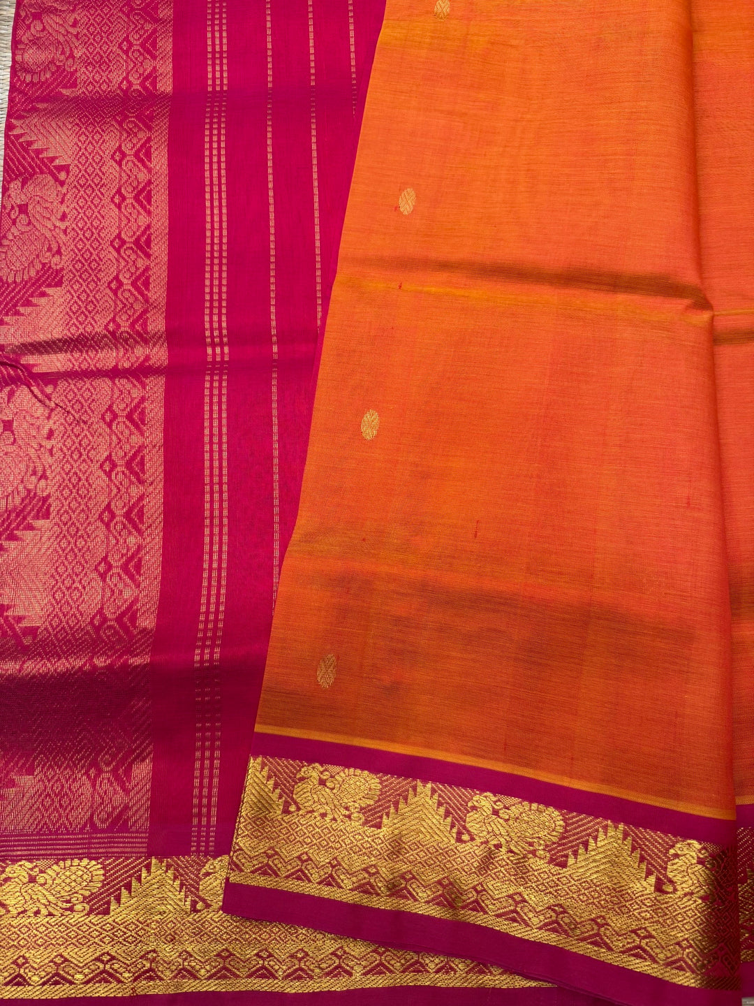 Sunset Orange with Red  ,  Rich  Zari Butta in the body , traditional borders and Rich Pallu Pure Silk Cotton Saree