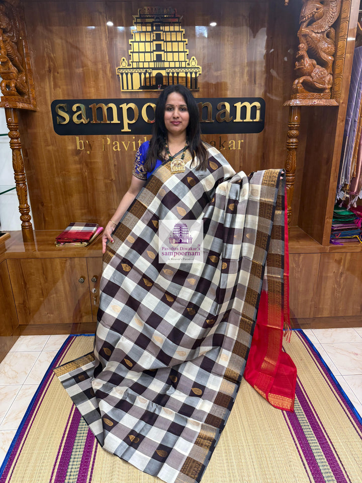 White , Brown  and Grey with Red , Mango butta in the body , traditional borders and rich Pallu Silk Cotton Saree