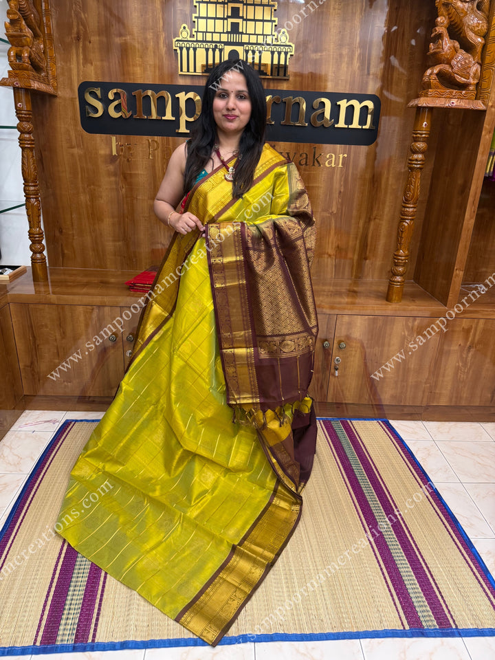Lemon Green with Brown , rich Zari checks in the body , Mayil and Chakram rich butta in the body , traditional border and rich Pallu Silk Cotton Saree