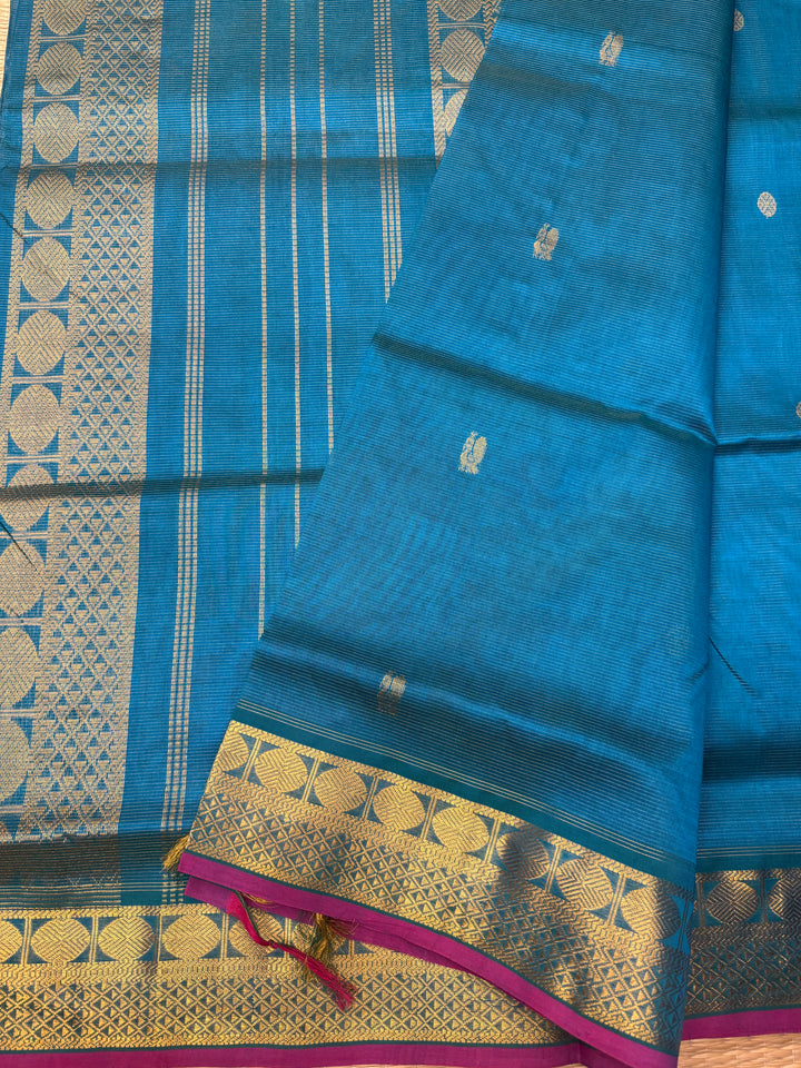 Double Shaded Chinthamani Blue , Pink Selvedge Vairaoosi Zari lines with Rich Annam and Rudraksh  Zari Butta in the body , traditional borders and Rich Pallu Pure Silk Cotton Saree