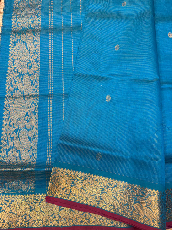 Ramar Blue , Red Selvedge Vairaoosi Zari lines with Rich Rudraksh Zari Butta in the body , traditional borders and Rich Pallu Pure Silk Cotton Saree