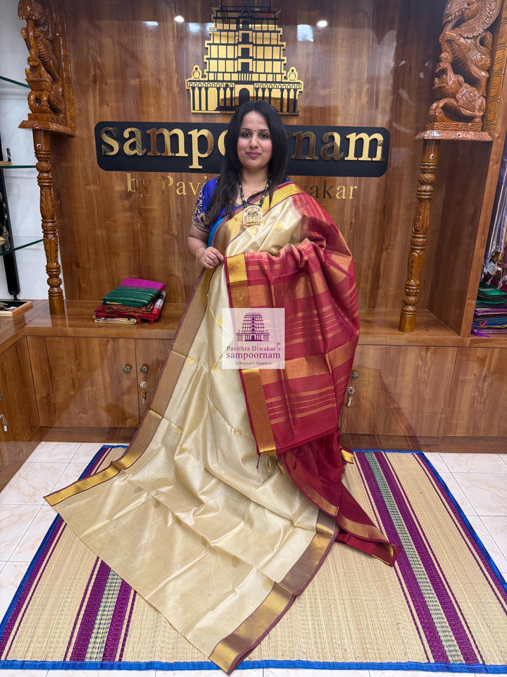 Light Gold with Red , rich Zari butta in the body , traditional border and traditional border and Rich Pallu Silk Cotton Saree