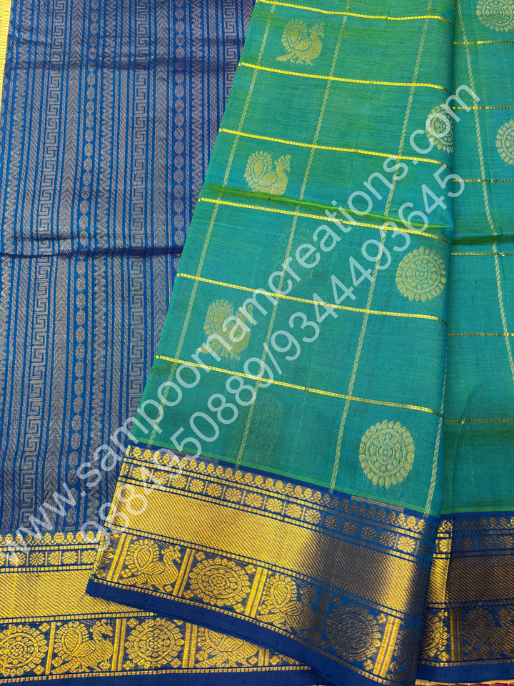 Double Shaded Teel Blue with Blue  , Rich Mayil and Chakram butta in the body with Zari Checks , Traditional borders and Rich Pallu Pure Silk Cotton Saree