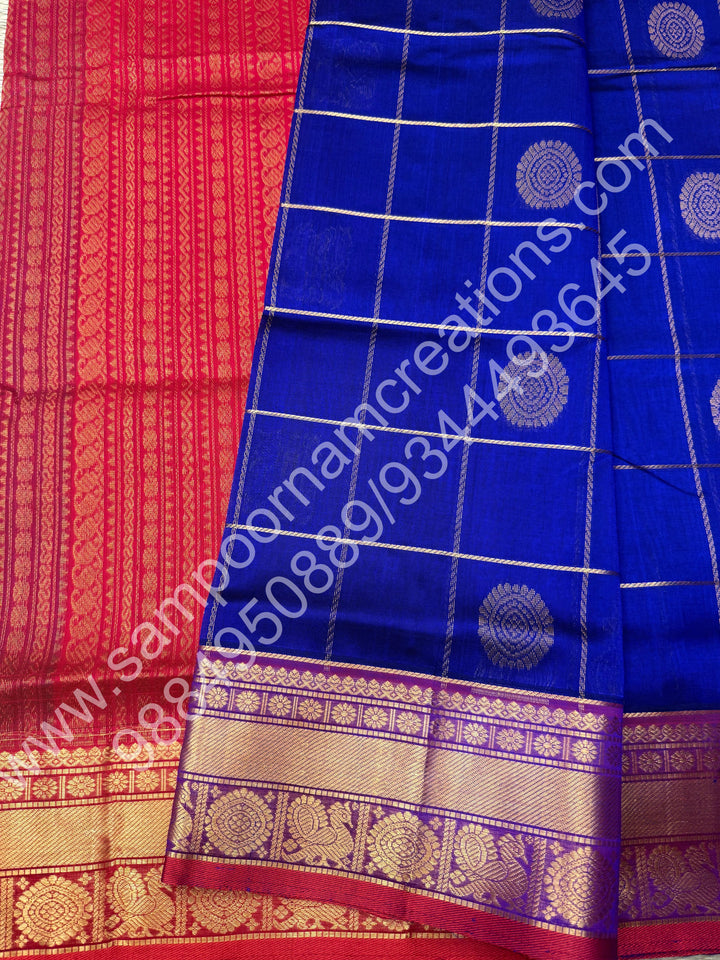 Indigo Blue with Red  , Rich Mayil and Chakram butta in the body with Zari Checks , Traditional borders and Rich Pallu Pure Silk Cotton Saree