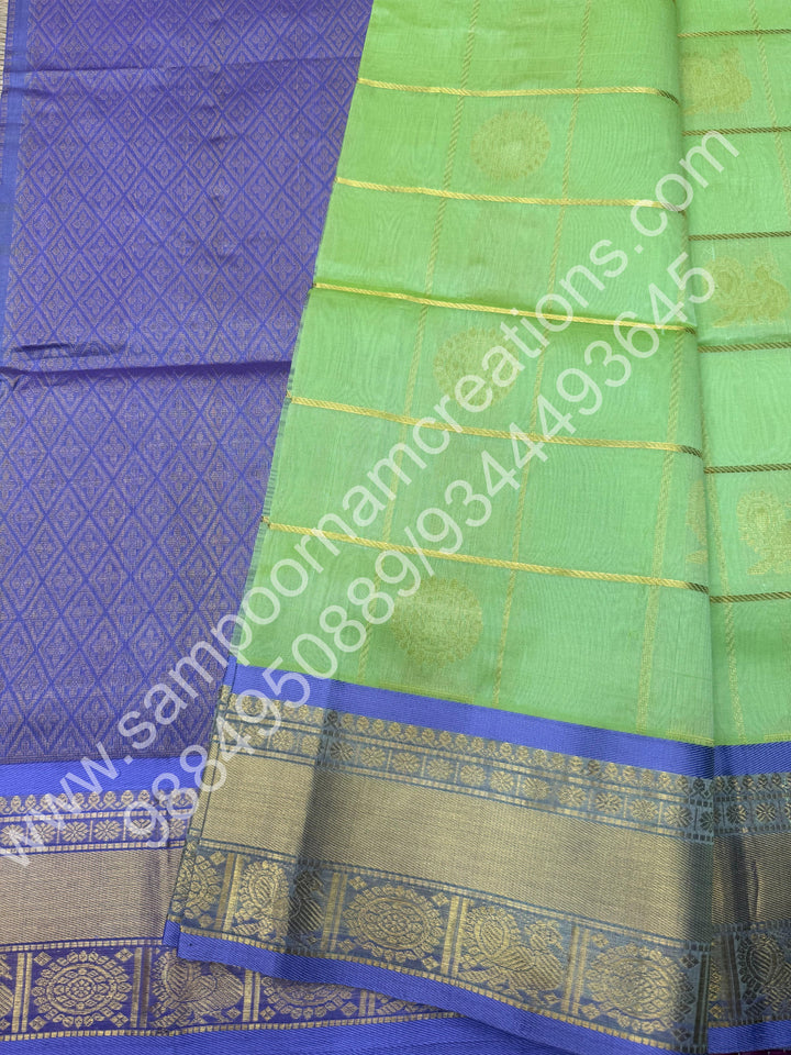 Pastel Green with Lavender  , Rich Mayil and Chakram butta in the body with Zari Checks , Traditional borders and Rich Pallu Pure Silk Cotton Saree