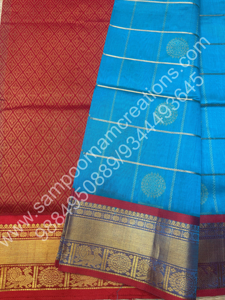 Ramar Blue with Red  , Rich Mayil and Chakram butta in the body with Zari Checks , Traditional borders and Rich Pallu Pure Silk Cotton Saree