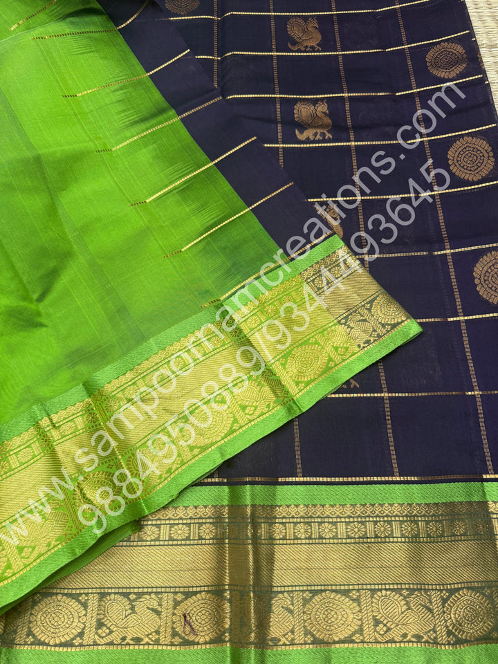 Dark Blue with parrot Green  , Rich Mayil and Chakram butta in the body with Zari Checks , Traditional borders and Rich Pallu Pure Silk Cotton Saree