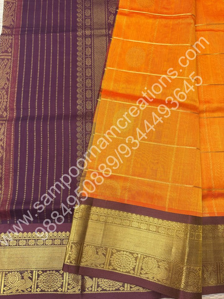 Orange with brown  , Rich Mayil and Chakram butta in the body with Zari Checks , Traditional borders and Rich Pallu Pure Silk Cotton Saree