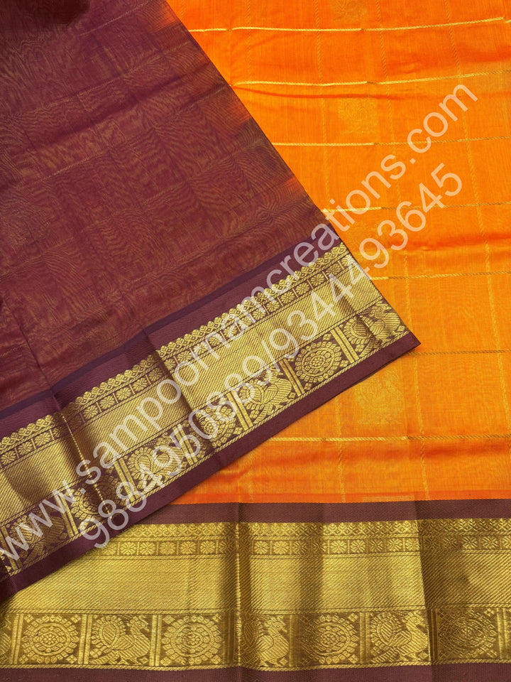 Orange with brown  , Rich Mayil and Chakram butta in the body with Zari Checks , Traditional borders and Rich Pallu Pure Silk Cotton Saree