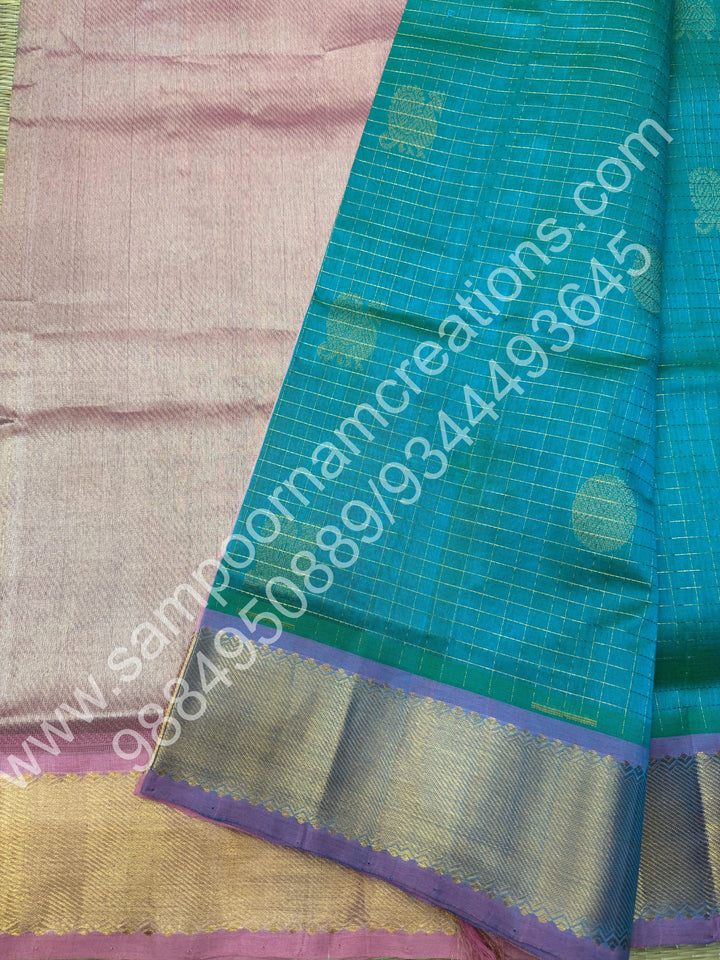 Double Shaded Sea Green with Baby Pink  , Rich Mayil and Chakram butta in the body with Zari Checks , Traditional borders and Rich Pallu Pure Silk Cotton Saree