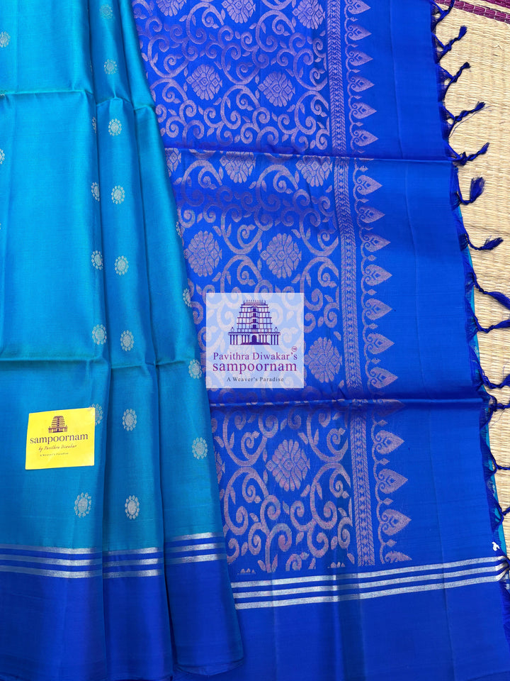Light Blue with Dark Blue , rich Zari Butta in the body , Plain borders , rich Pallu Handloom Semi Soft Silk Saree