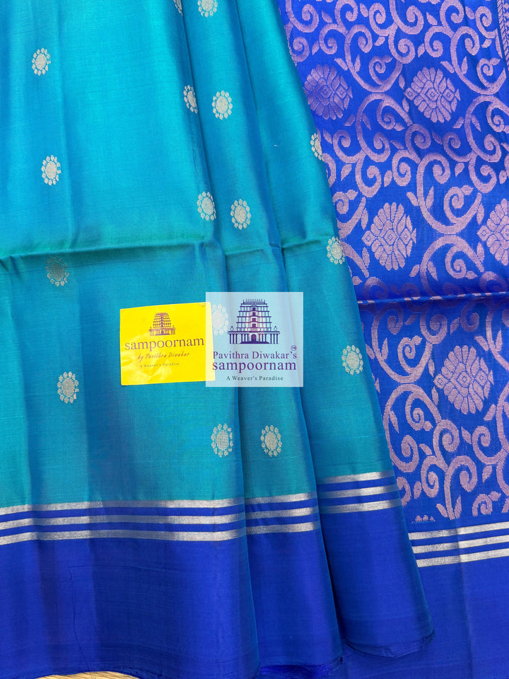 Light Blue with Dark Blue , rich Zari Butta in the body , Plain borders , rich Pallu Handloom Semi Soft Silk Saree