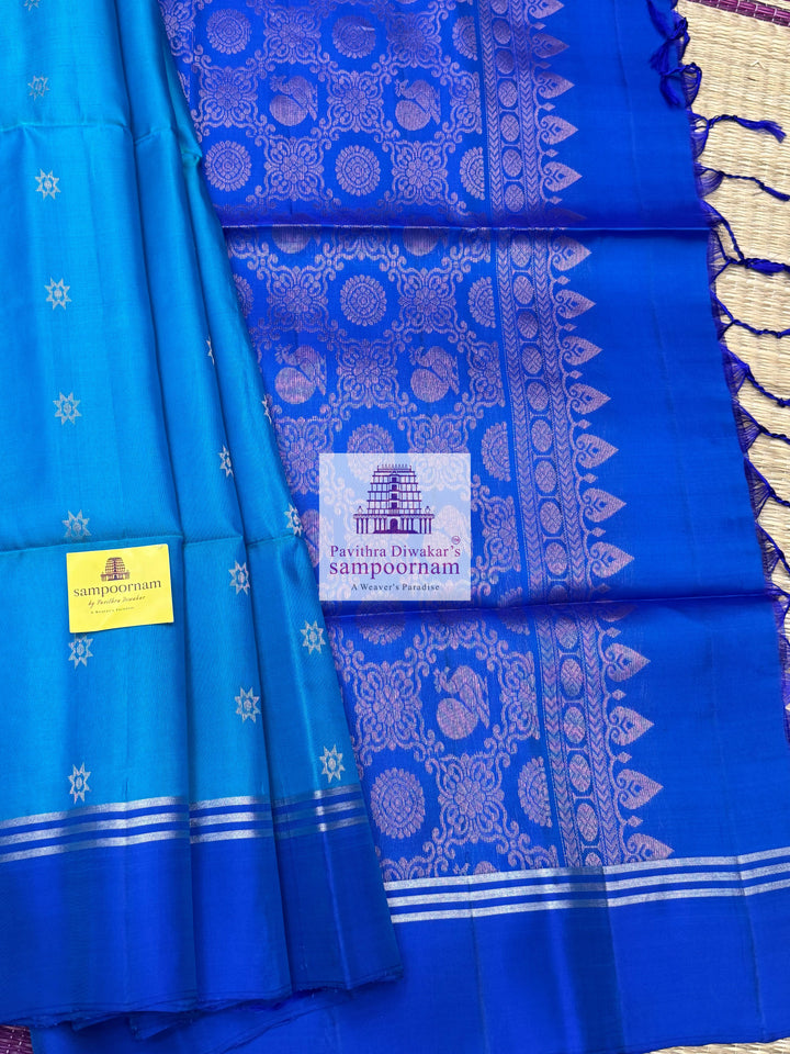 Blue with Dark Blue , rich Zari Butta in the body , Plain borders , rich Pallu Handloom Semi Soft Silk Saree