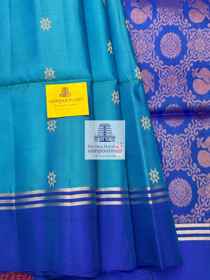 Blue with Dark Blue , rich Zari Butta in the body , Plain borders , rich Pallu Handloom Semi Soft Silk Saree