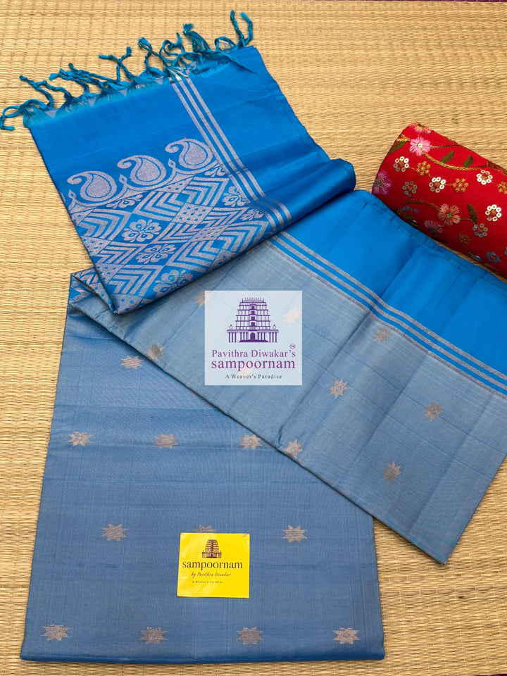 Light Blue with Blue , rich Zari Butta in the body , Plain borders , rich Pallu Handloom Semi Soft Silk Saree