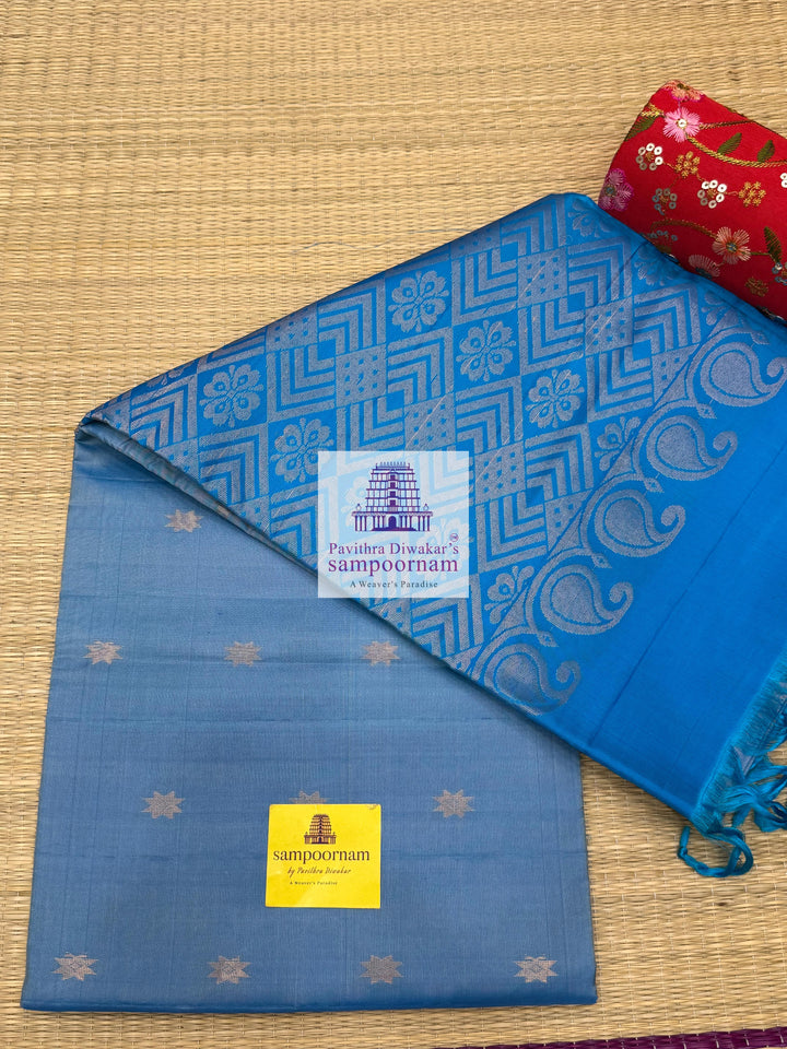 Light Blue with Blue , rich Zari Butta in the body , Plain borders , rich Pallu Handloom Semi Soft Silk Saree
