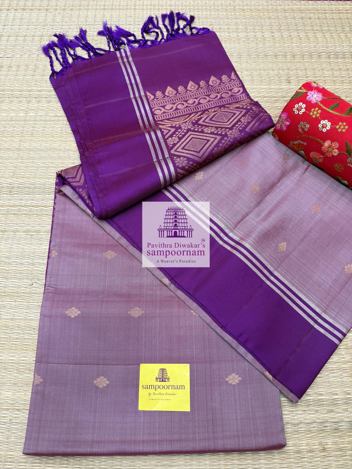 Mauve with Purple , rich Zari Butta in the body , Plain borders , rich Pallu Handloom Semi Soft Silk Saree