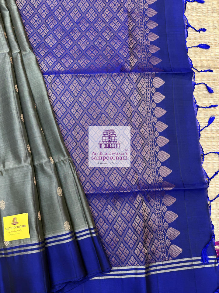Greenish Grey with Dark Blue , rich Zari Butta in the body , Plain borders , rich Pallu Handloom Semi Soft Silk Saree
