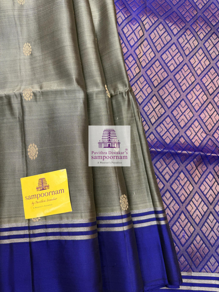 Greenish Grey with Dark Blue , rich Zari Butta in the body , Plain borders , rich Pallu Handloom Semi Soft Silk Saree