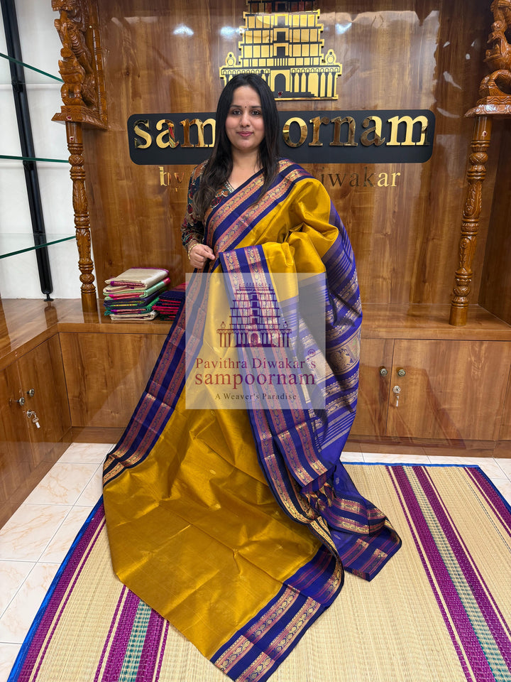 Dark Gold with Dark Blue , Zari butta in the body , rettapet borders and Zari checks in the body , rich Pallu Korvai Silk Cotton Saree