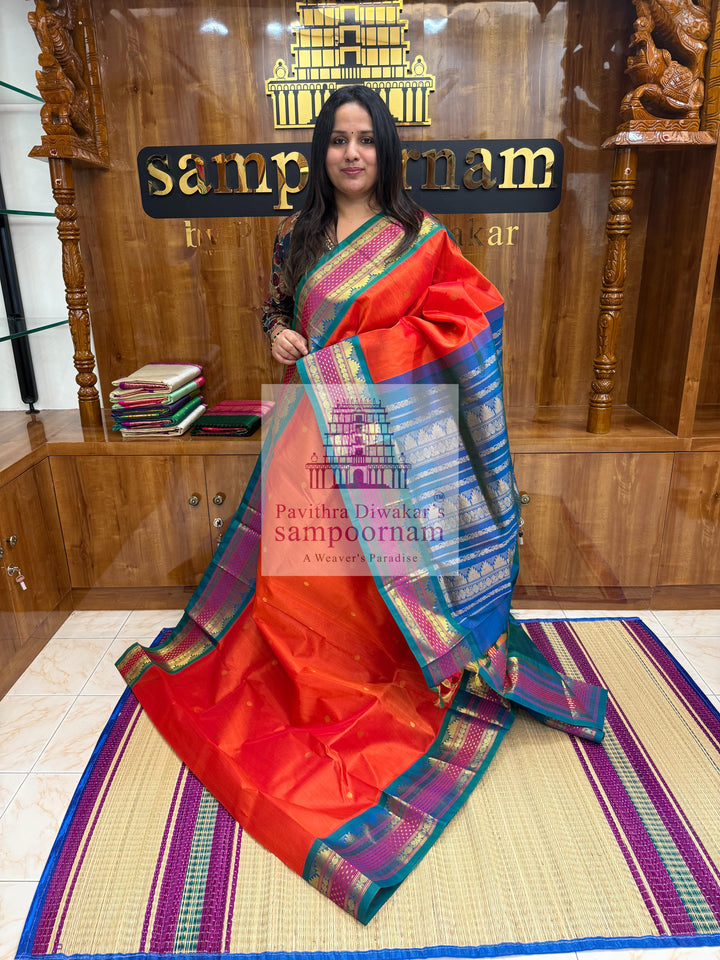 Rust Orange with Mayikazhuthu Blue , Lakshadeepam borders and rich Pallu Zari butta in the body Korvai Silk Cotton Saree