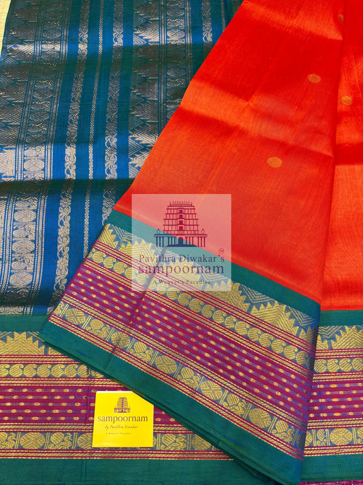 Rust Orange with Mayikazhuthu Blue , Lakshadeepam borders and rich Pallu Zari butta in the body Korvai Silk Cotton Saree