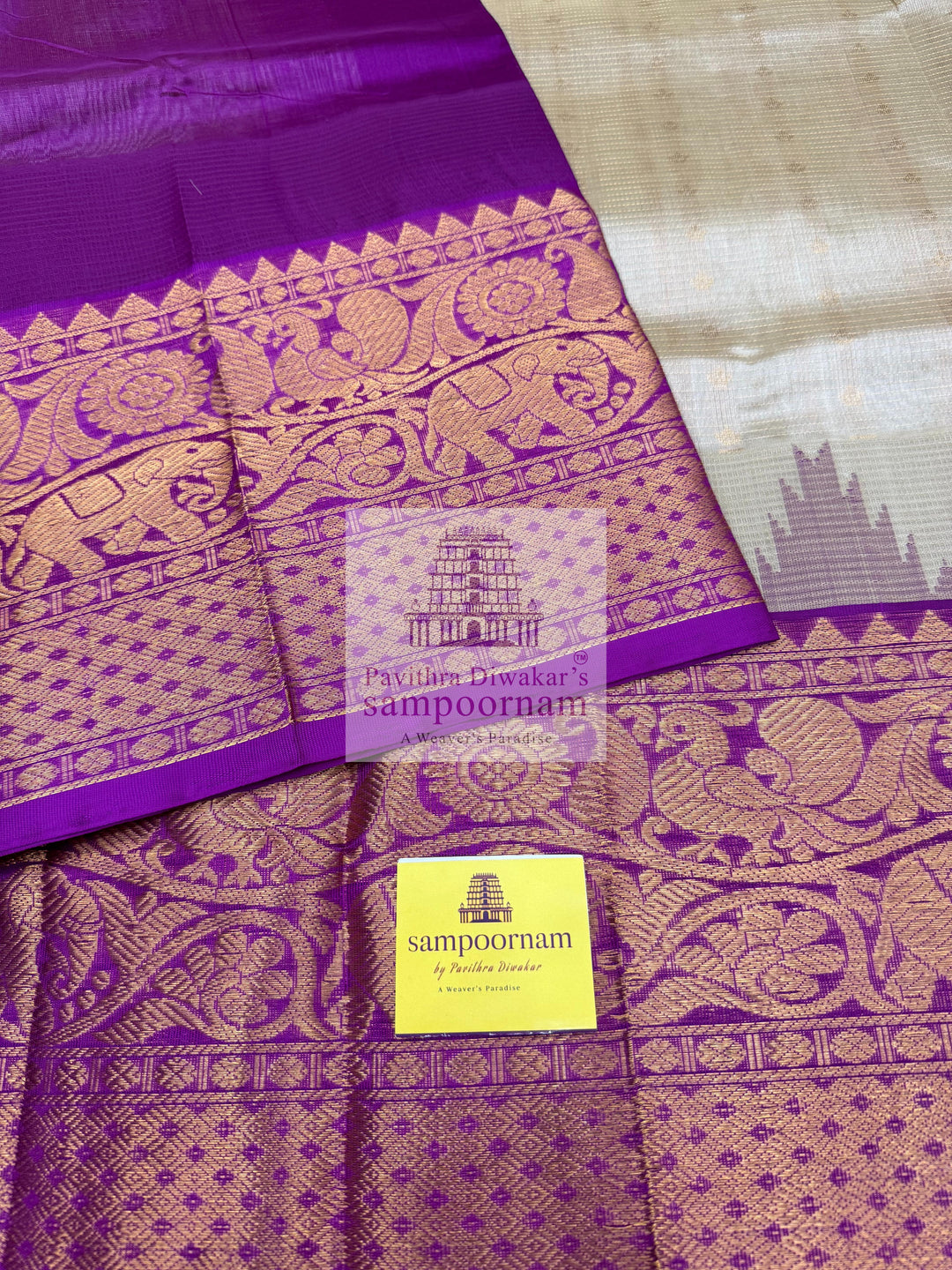 Beige with Purple , Zari Podi Kattam in the body , traditional one side short and long borders with rich Pallu Korvai Silk Cotton Saree