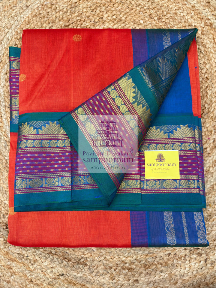 Rust Orange with Mayikazhuthu Blue , Lakshadeepam borders and rich Pallu Zari butta in the body Korvai Silk Cotton Saree