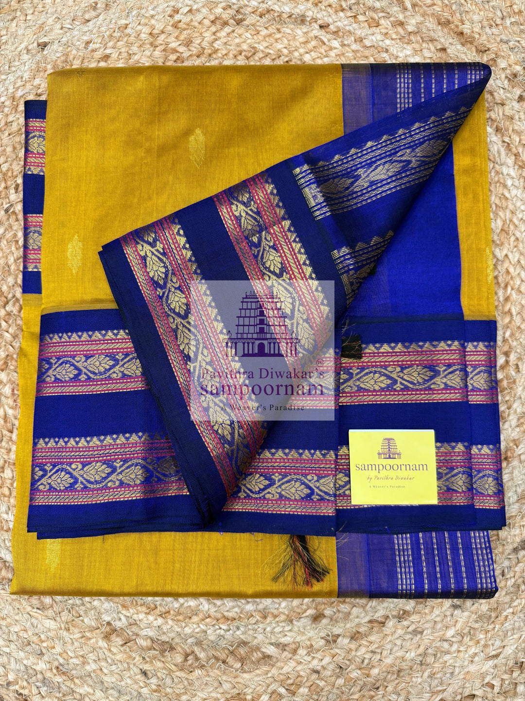Dark Gold with Dark Blue , Zari butta in the body , rettapet borders and Zari checks in the body , rich Pallu Korvai Silk Cotton Saree