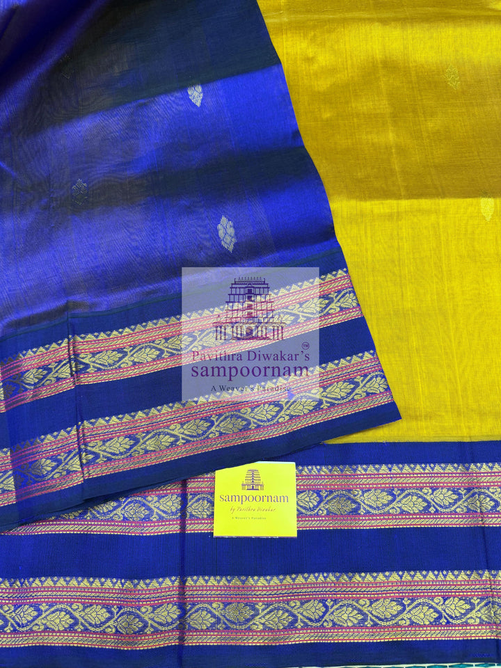 Dark Gold with Dark Blue , Zari butta in the body , rettapet borders and Zari checks in the body , rich Pallu Korvai Silk Cotton Saree