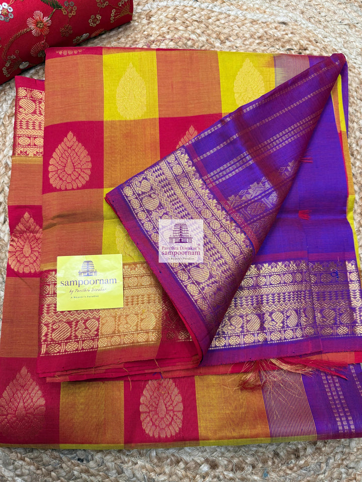Red , Orange and Mustard with Purple , Mango butta in the body , traditional borders and rich Pallu Silk Cotton Saree