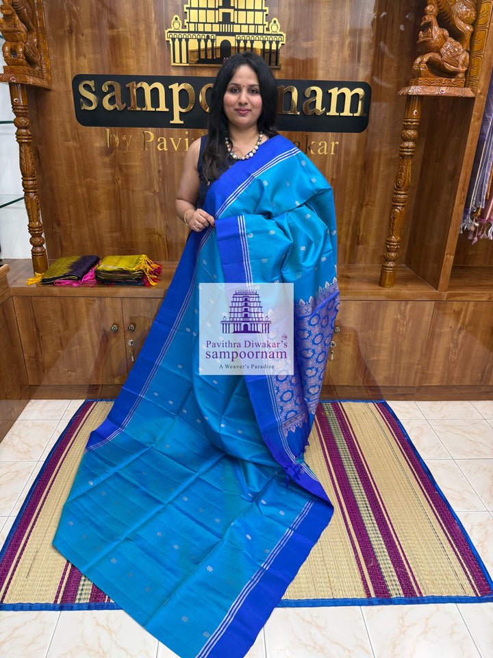Blue with Dark Blue , rich Zari Butta in the body , Plain borders , rich Pallu Handloom Semi Soft Silk Saree