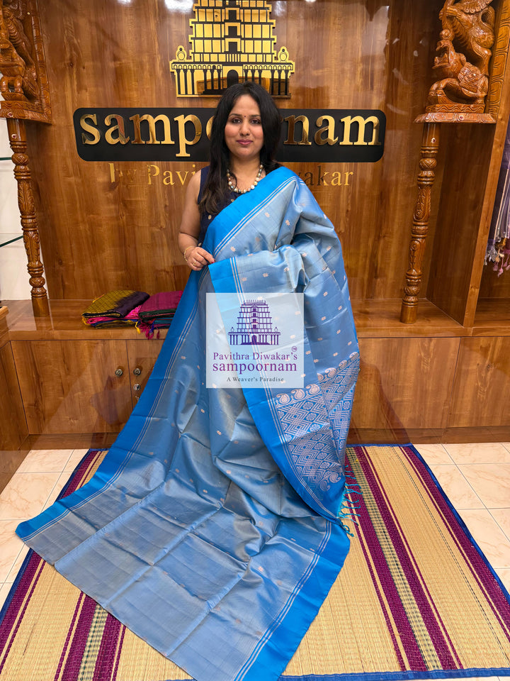 Light Blue with Blue , rich Zari Butta in the body , Plain borders , rich Pallu Handloom Semi Soft Silk Saree