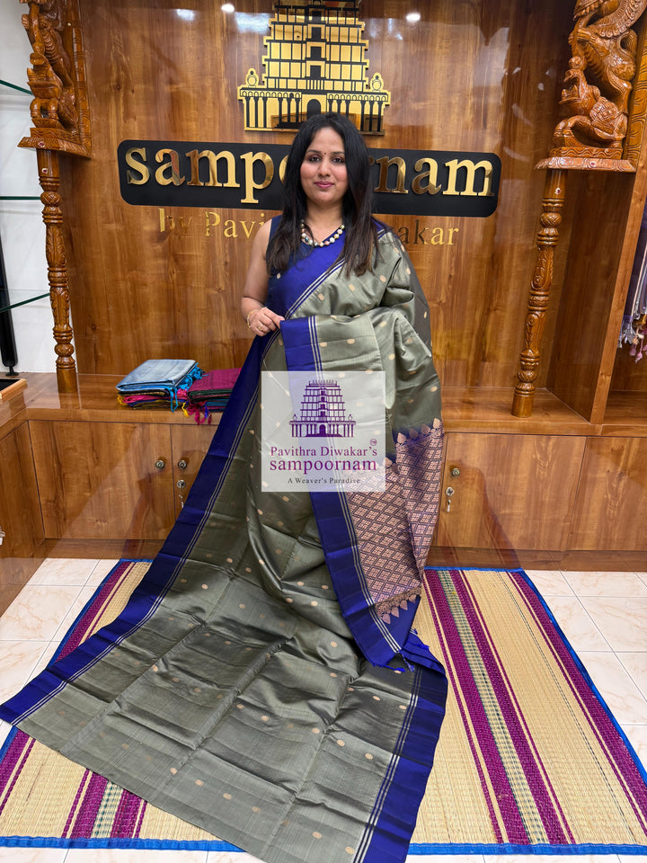 Greenish Grey with Dark Blue , rich Zari Butta in the body , Plain borders , rich Pallu Handloom Semi Soft Silk Saree