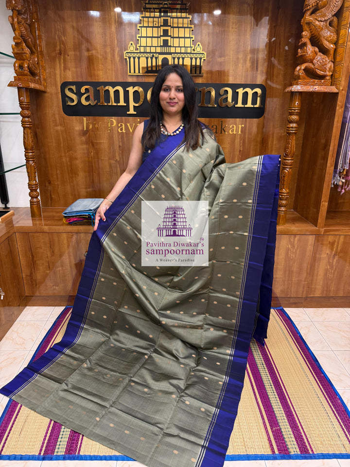 Greenish Grey with Dark Blue , rich Zari Butta in the body , Plain borders , rich Pallu Handloom Semi Soft Silk Saree