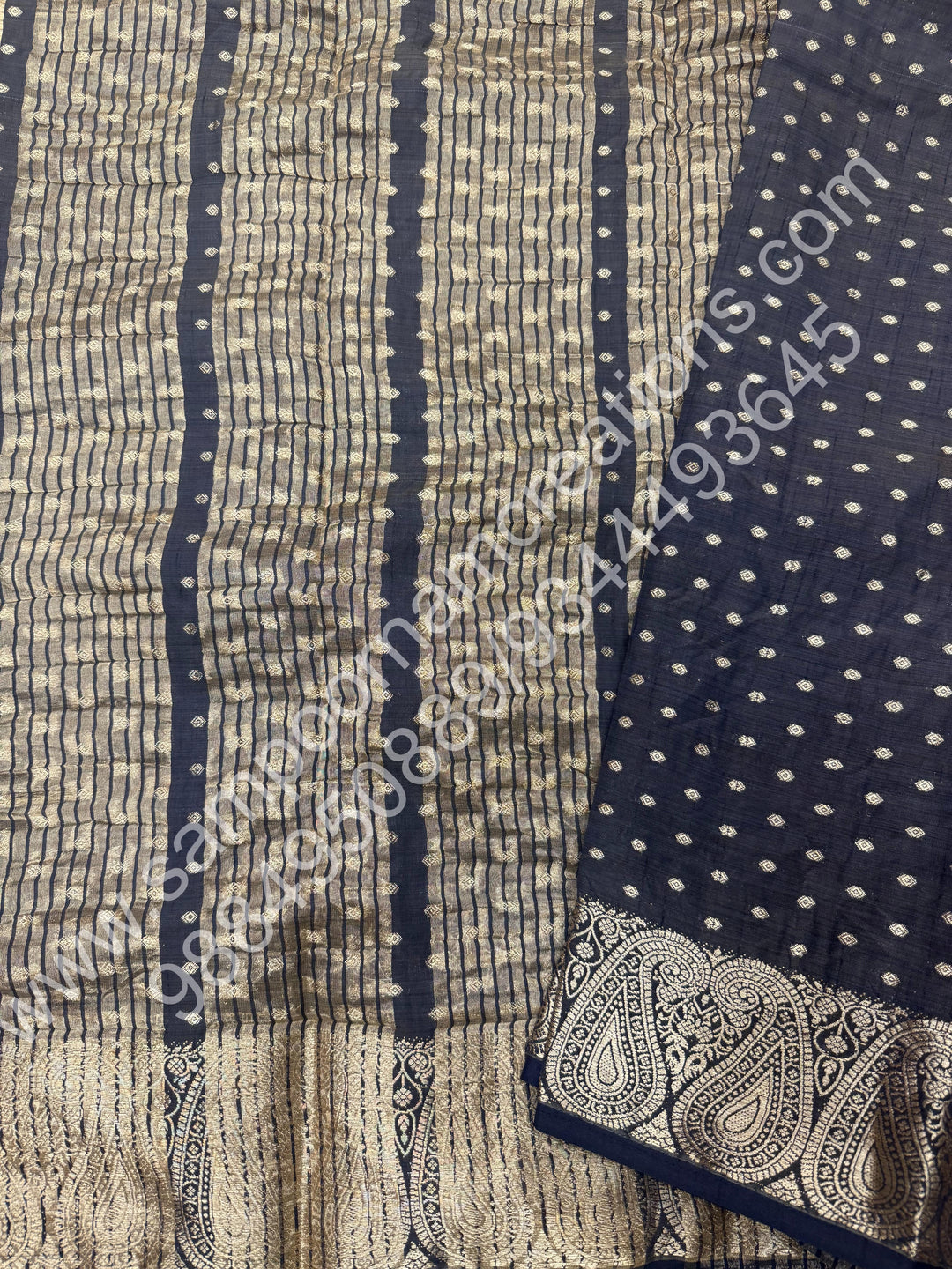 Black with Zari Buttas all over the body , Traditional rich Mango designs in the border and Tissue Pallu , Semi Tussar Saree