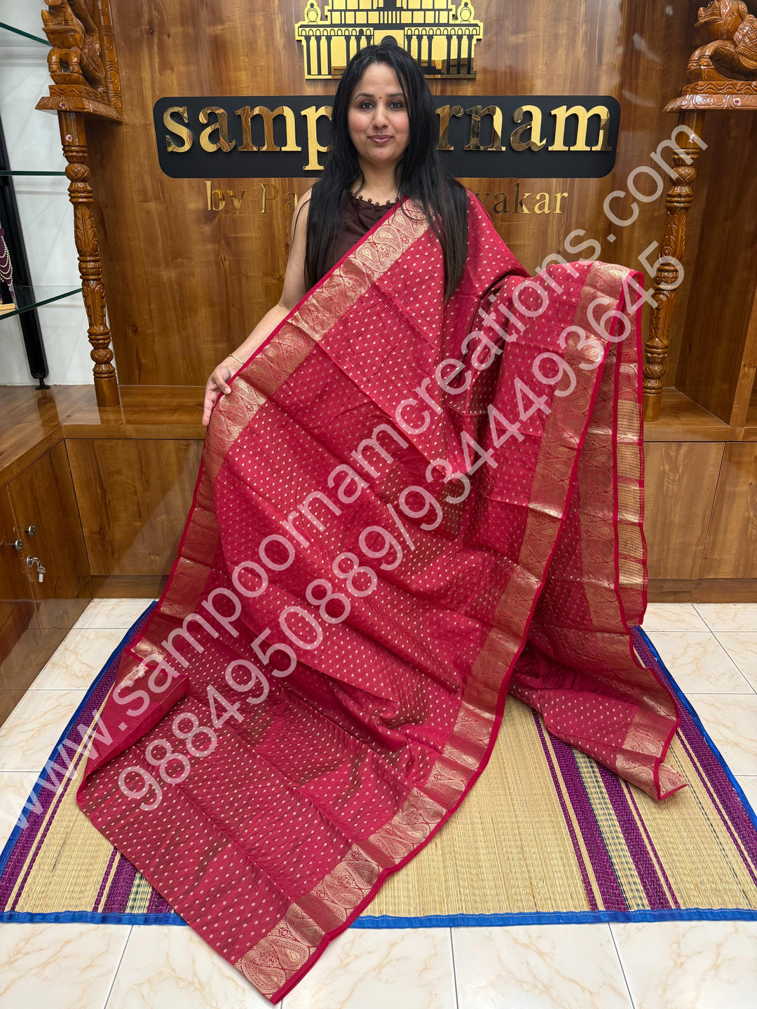 Red with Zari Buttas all over the body , Traditional rich Mango designs in the border and Tissue Pallu , Semi Tussar Saree