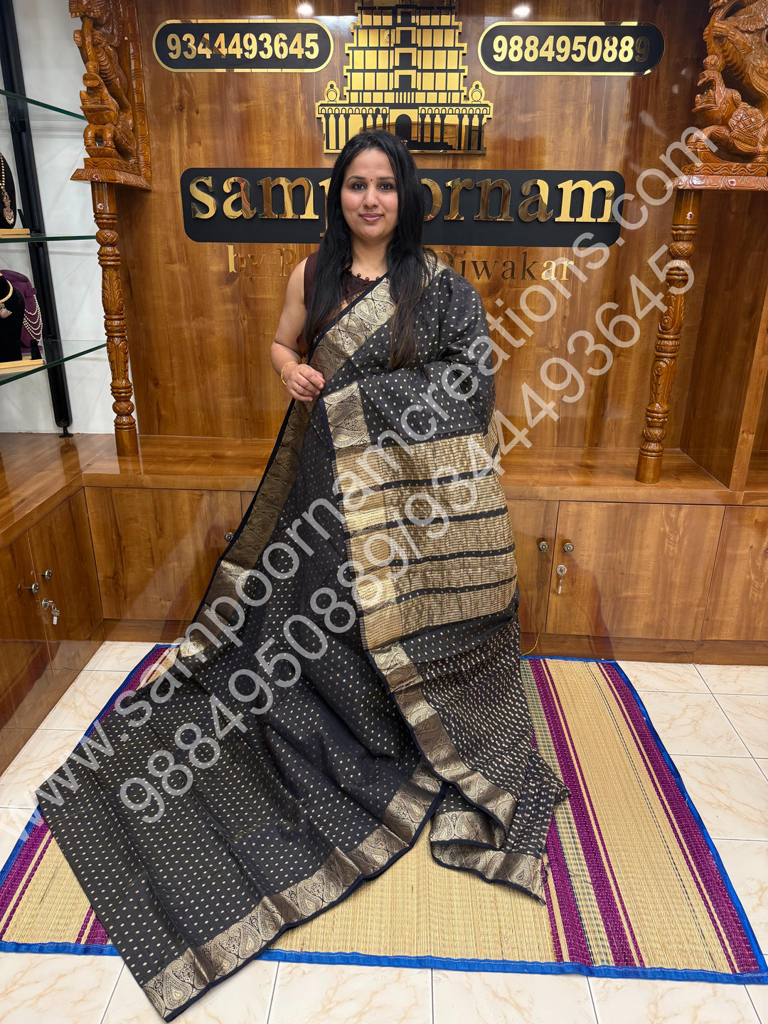 Black with Zari Buttas all over the body , Traditional rich Mango designs in the border and Tissue Pallu , Semi Tussar Saree