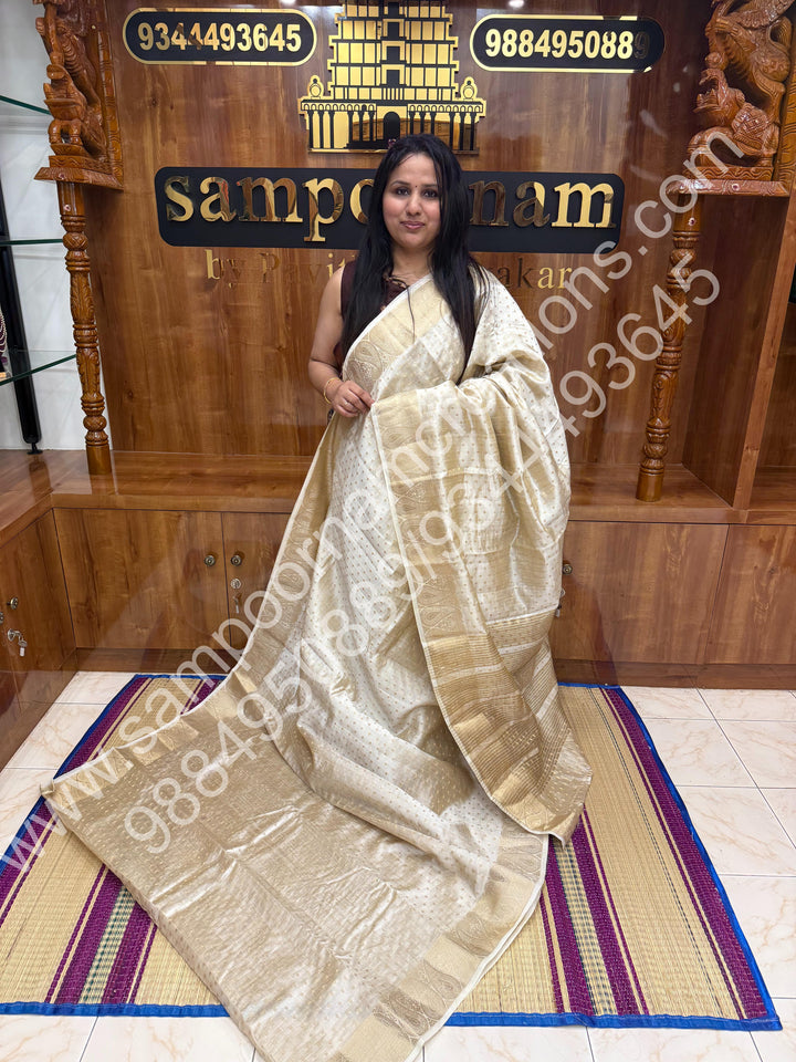 Offwhite with Zari Buttas all over the body , Traditional rich Mango designs in the border and Tissue Pallu , Semi Tussar Saree