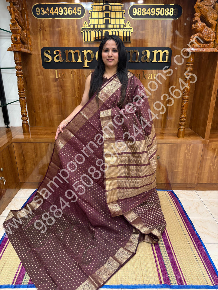 Burgundy with Zari Buttas all over the body , Traditional rich Mango designs in the border and Tissue Pallu , Semi Tussar Saree