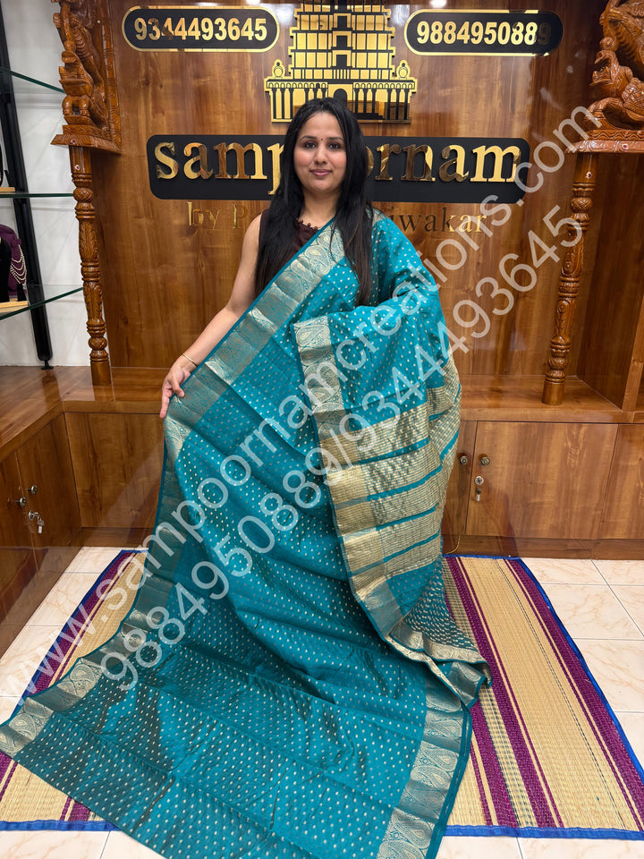 Turquoise Blue with Zari Buttas all over the body , Traditional rich Mango designs in the border and Tissue Pallu , Semi Tussar Saree