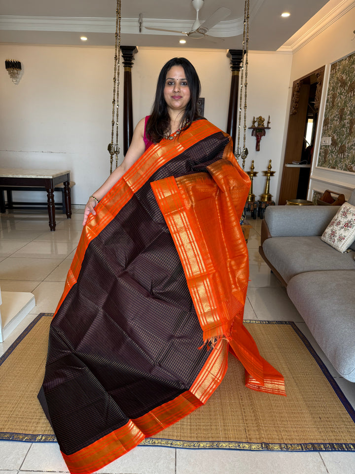 Dark Coffee Brown with Fanta Orange colour ,rich zari checks in the body ,traditional borders  and rich pallu Korvai Silk Cotton Saree