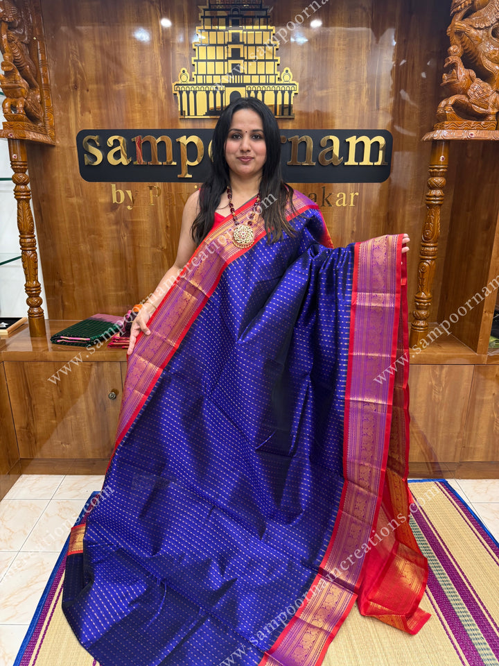 Blue with Red , rich Lakshadeepam Zari butta in the body and traditional borders , grand Pallu Silk Cotton Saree