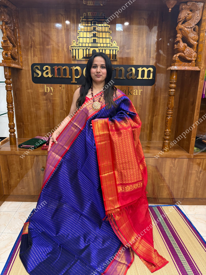 Blue with Red , rich Lakshadeepam Zari butta in the body and traditional borders , grand Pallu Silk Cotton Saree