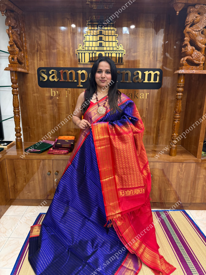 Blue with Red , rich Lakshadeepam Zari butta in the body and traditional borders , grand Pallu Silk Cotton Saree