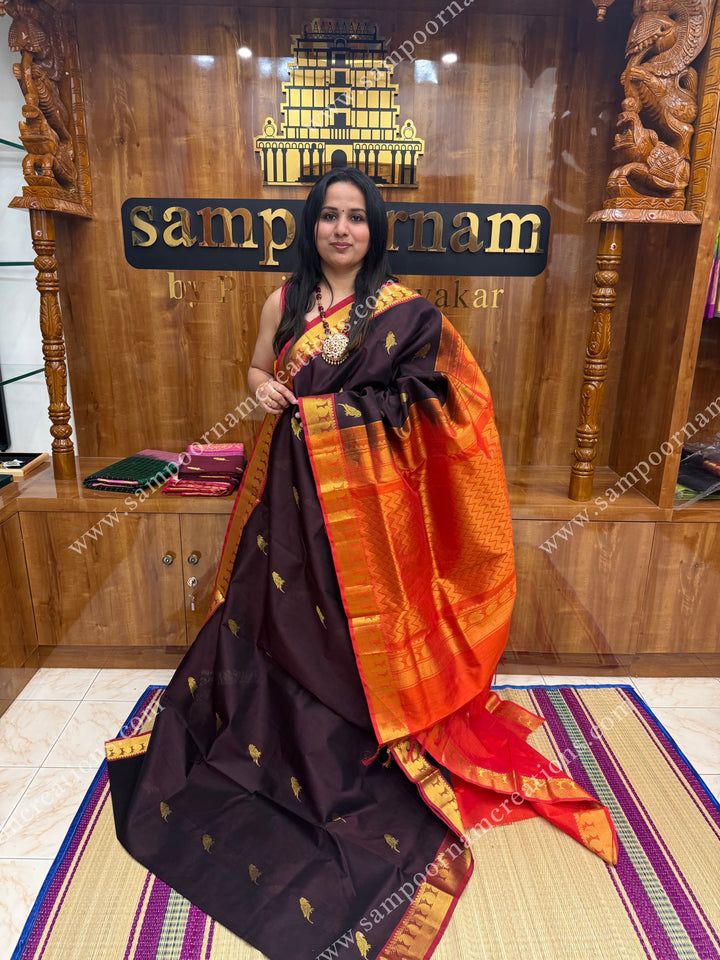 Dark Brown with Orange , Parrot Zari motif in the body and  traditional border , grand Pallu Silk Cotton Saree